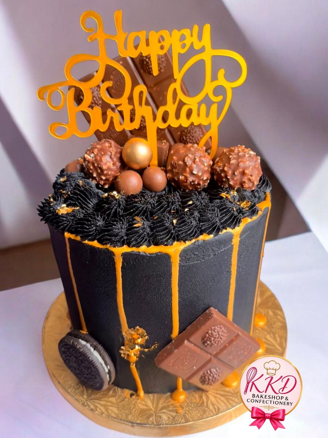Black and gold birthday drip cake loaded with chocolate